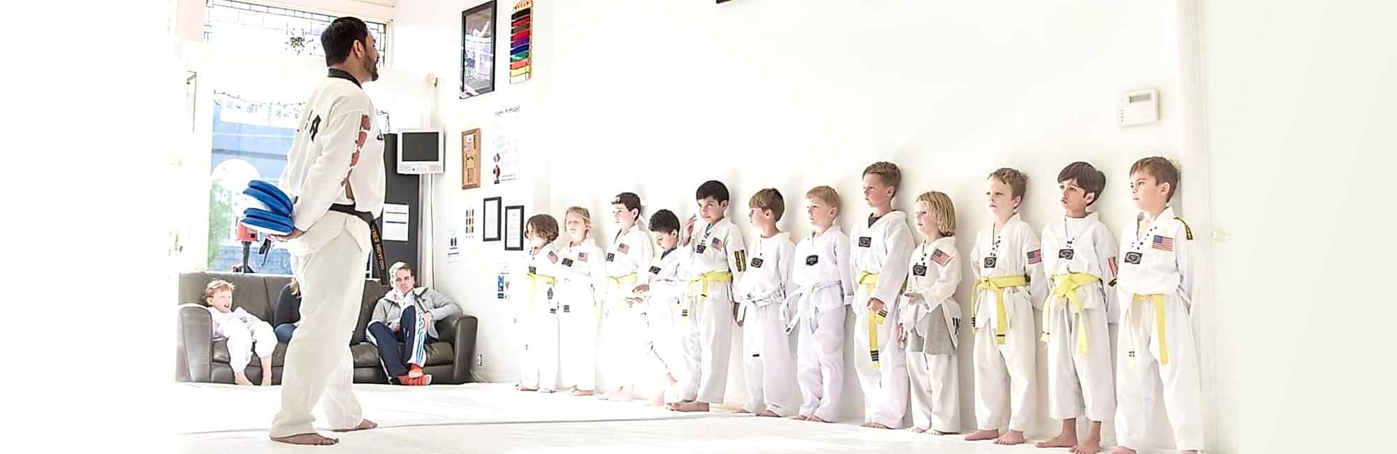 children lined up ready for martial arts class